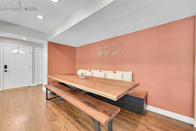 a view of a room with wooden floor and bench