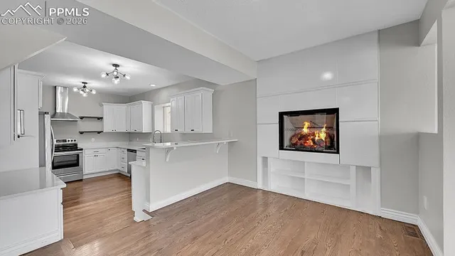 a view of kitchen with cabinets and wooden floor