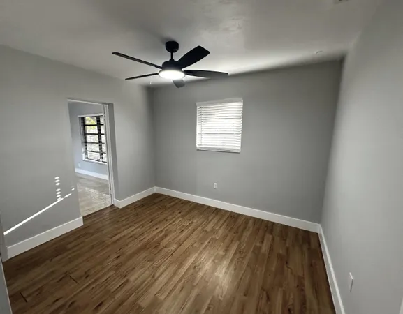 wooden floor in an empty room with a window