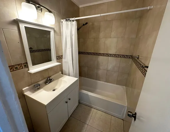 a bathroom with a sink mirror and shower