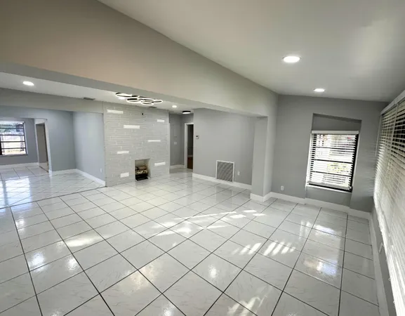 a view of an empty room and a window