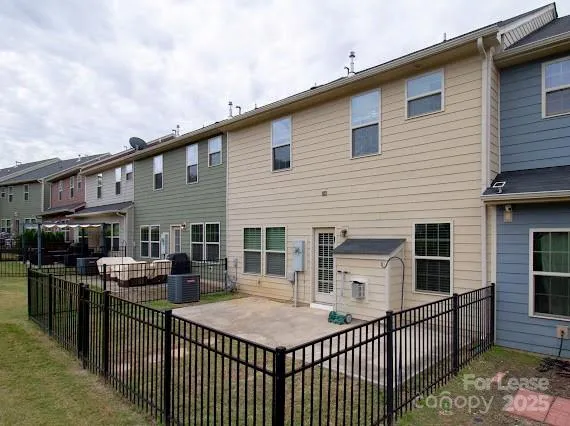 a view of a house with large wooden fence