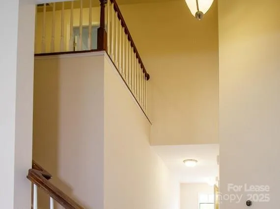 an empty room with windows a fireplace and wooden floor