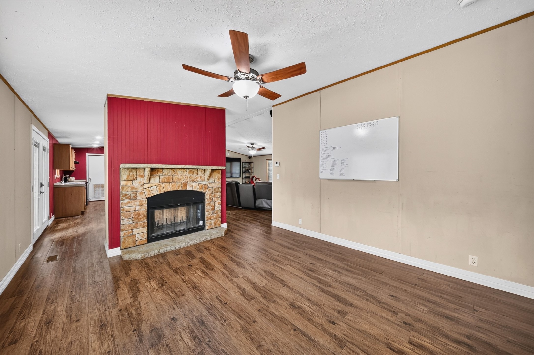 2581 Mann Road Conroe, TX 77303 - Photo 13 of 32 Spacious living area with fireplace and flexible room for multiple furniture arrangements.