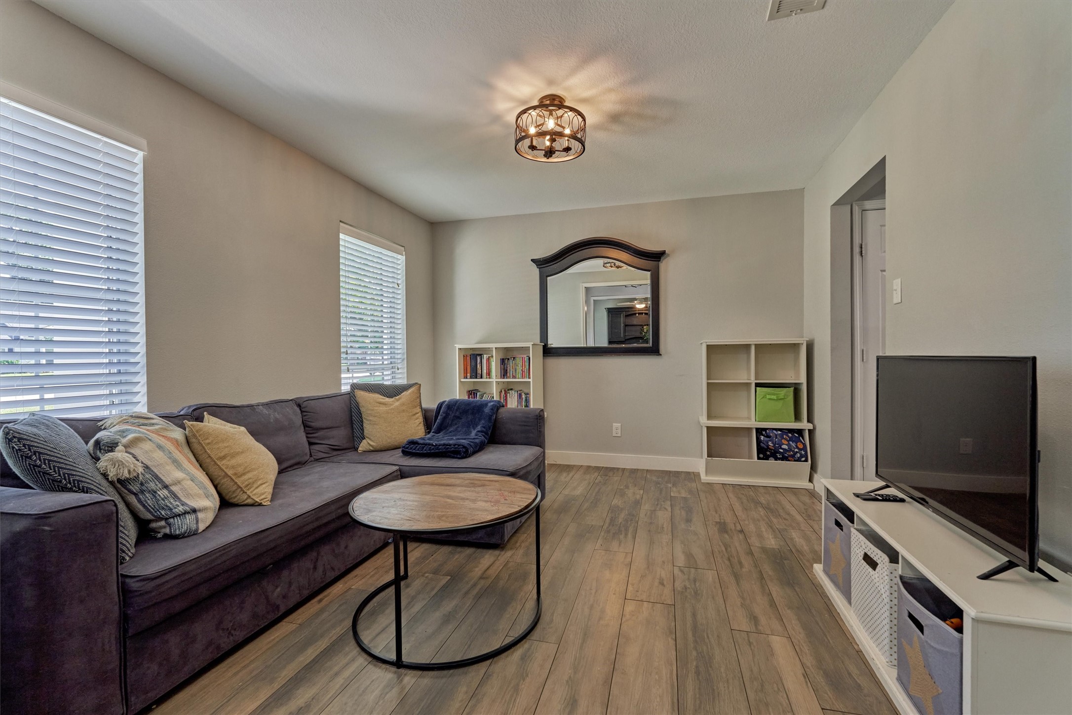 6515 Glenhill Drive Spring, TX 77389 - Photo 7 of 39 a living room with furniture and a flat screen tv