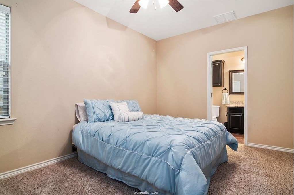3201 Corporal Road College Station, TX 77845 - Photo 7 of 10 a bedroom with a bed and a chandelier