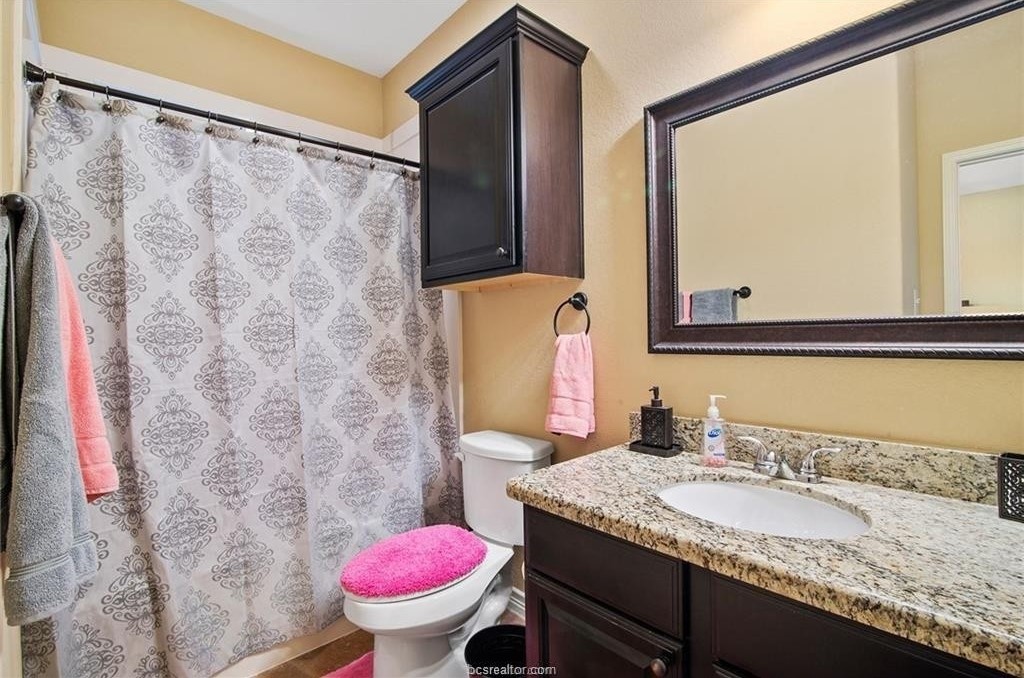 3201 Corporal Road College Station, TX 77845 - Photo 8 of 10 a bathroom with a granite countertop sink and a mirror