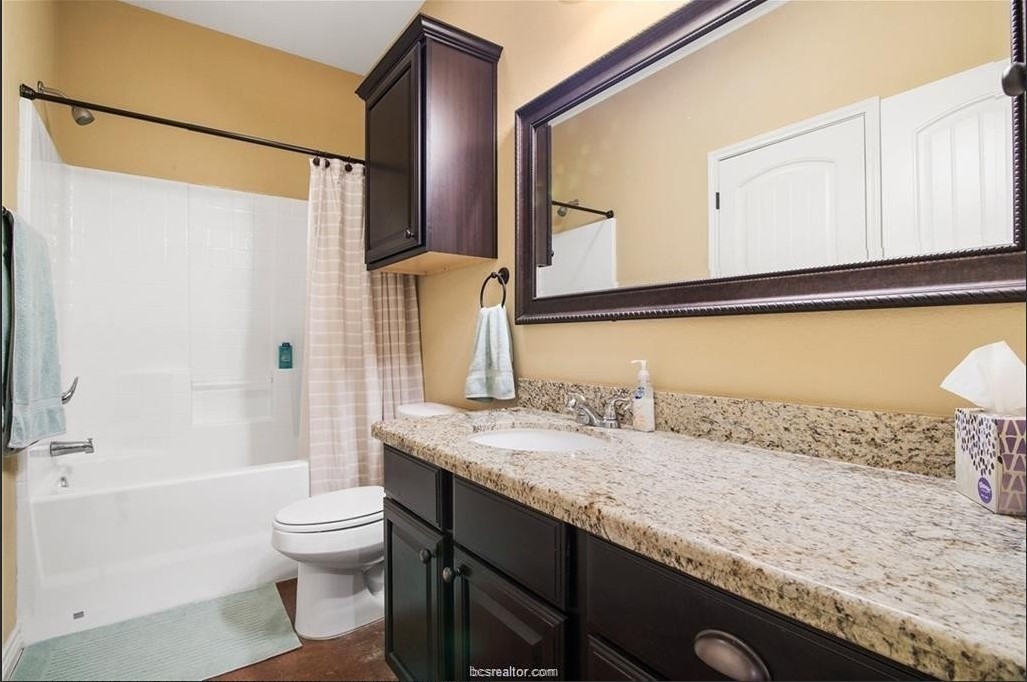 3201 Corporal Road College Station, TX 77845 - Photo 10 of 10 a bathroom with a granite countertop sink and a mirror