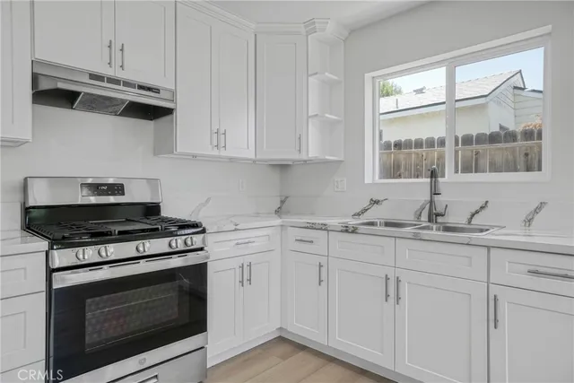 a kitchen with white cabinets and appliances