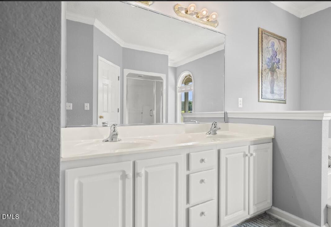 5780 McArthur Road Broadway, NC 27505 - Photo 24 of 40 a bathroom with a double vanity sink and a mirror