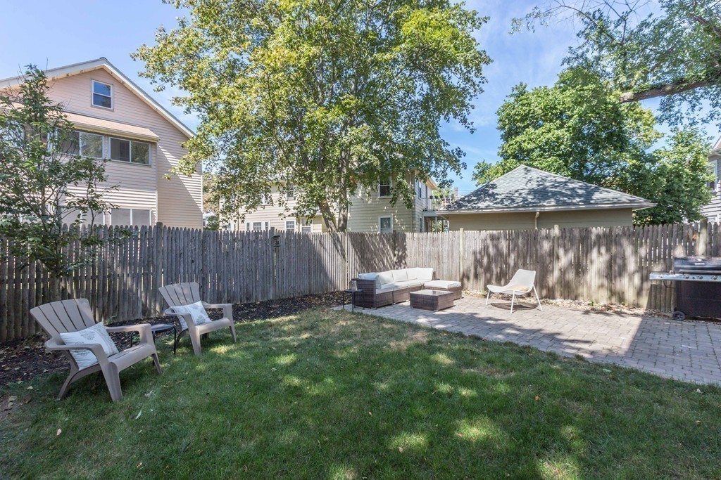 32 Skahan Road, Unit 32 Belmont, MA 02478 - Photo 16 of 18 a view of a chair and table in backyard of the house