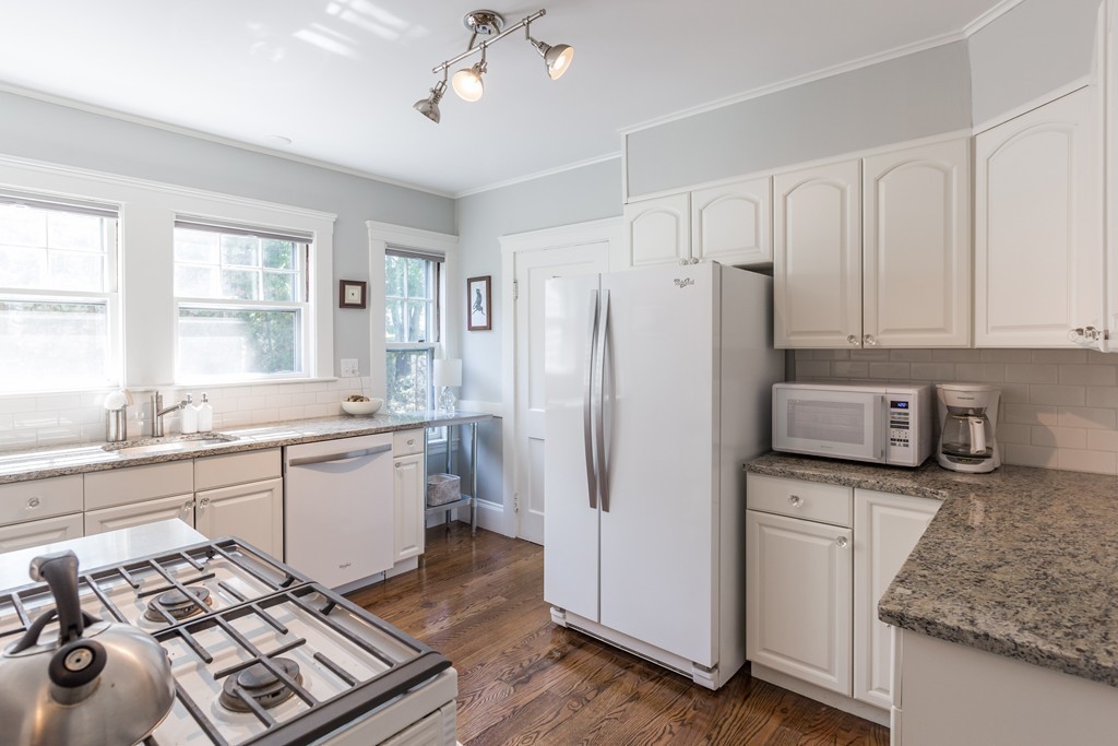 32 Skahan Road, Unit 32 Belmont, MA 02478 - Photo 8 of 18 a kitchen with a sink stove and refrigerator