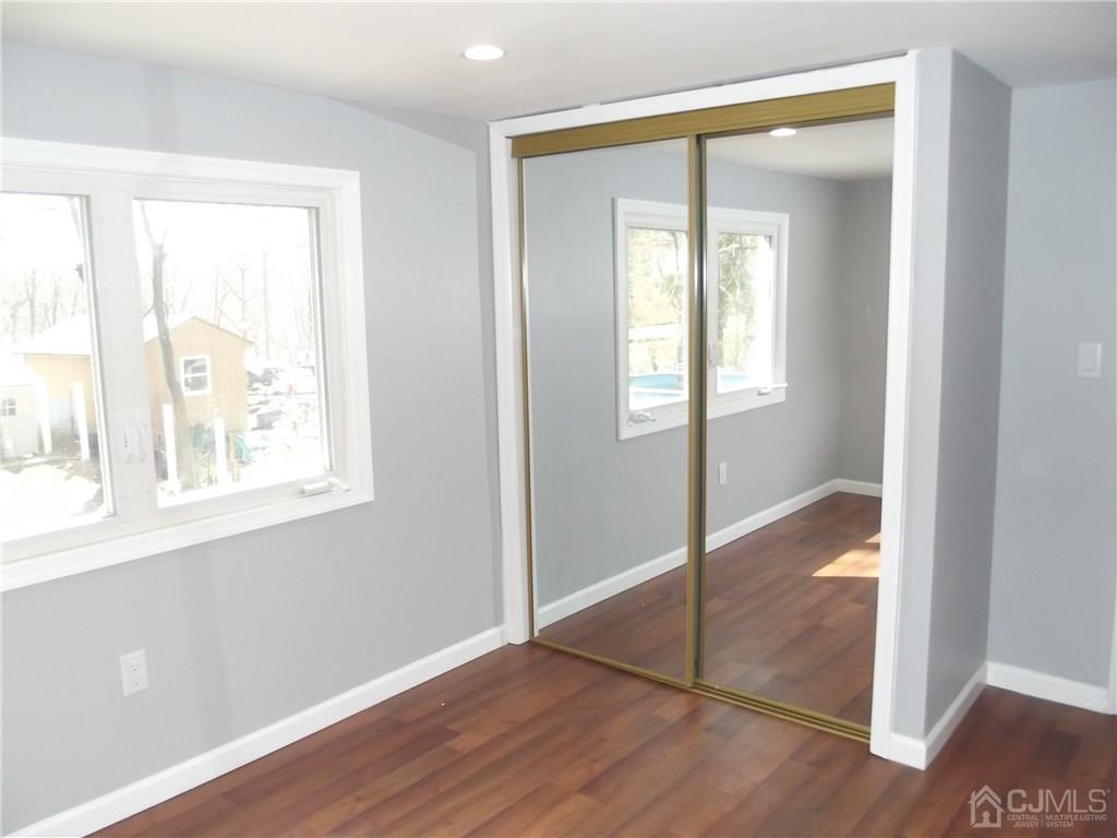 16 Pennington Road New Brunswick, NJ 08901 - Photo 12 of 17 a view of an empty room with wooden floor and a window