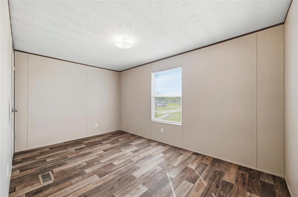 205 Park Street Frost, TX 76641 - Photo 14 of 19 a view of empty room with wooden floor and fan