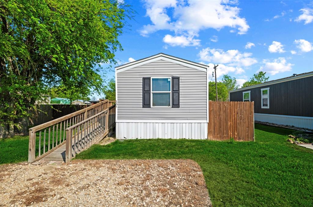 205 Park Street Frost, TX 76641 - Photo 2 of 19 a front view of a house with garden