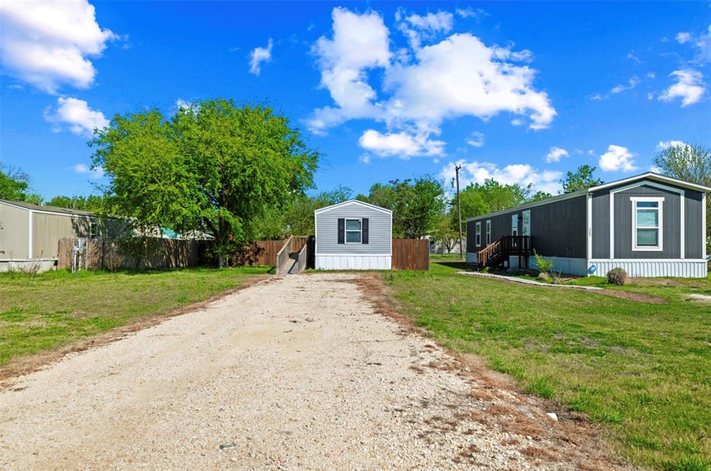 205 Park Street Frost, TX 76641 - Photo 3 of 19 a front view of a house with garden