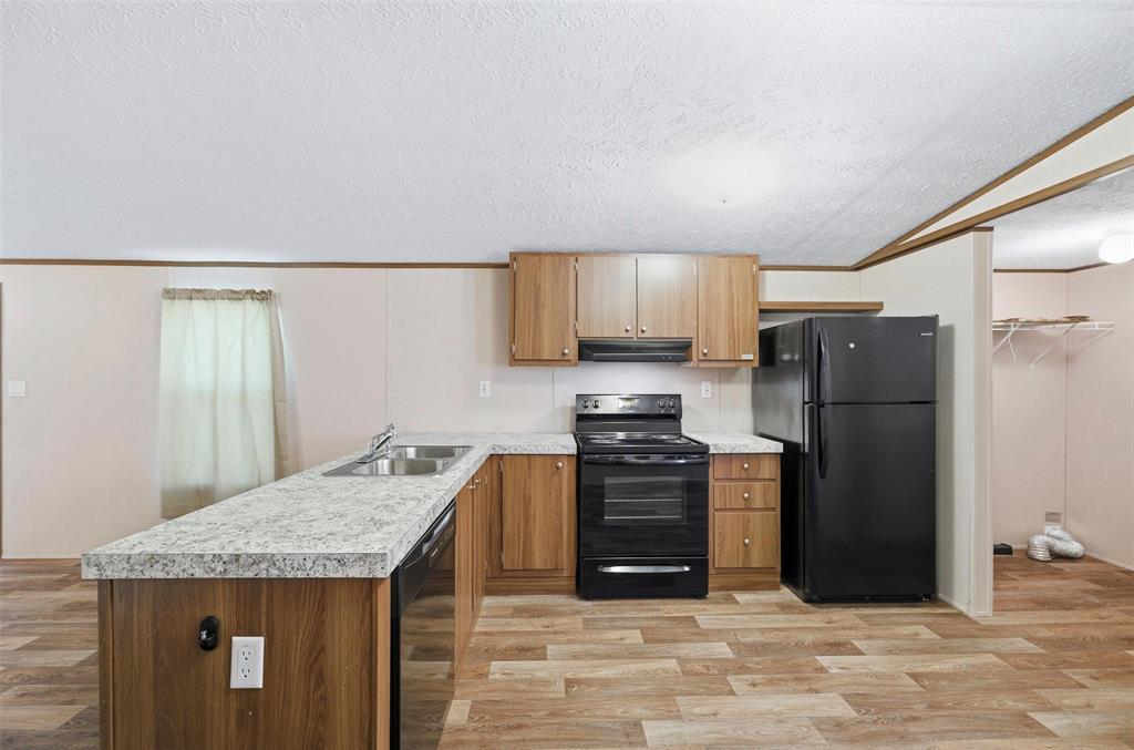 205 Park Street Frost, TX 76641 - Photo 6 of 19 a kitchen with stainless steel appliances granite countertop a refrigerator stove and oven