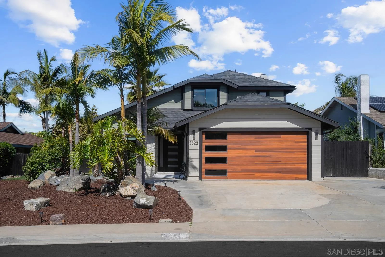 3523 Chauncey Road Oceanside, CA 92056 - Photo 1 of 34 a front view of a house with a yard and garage