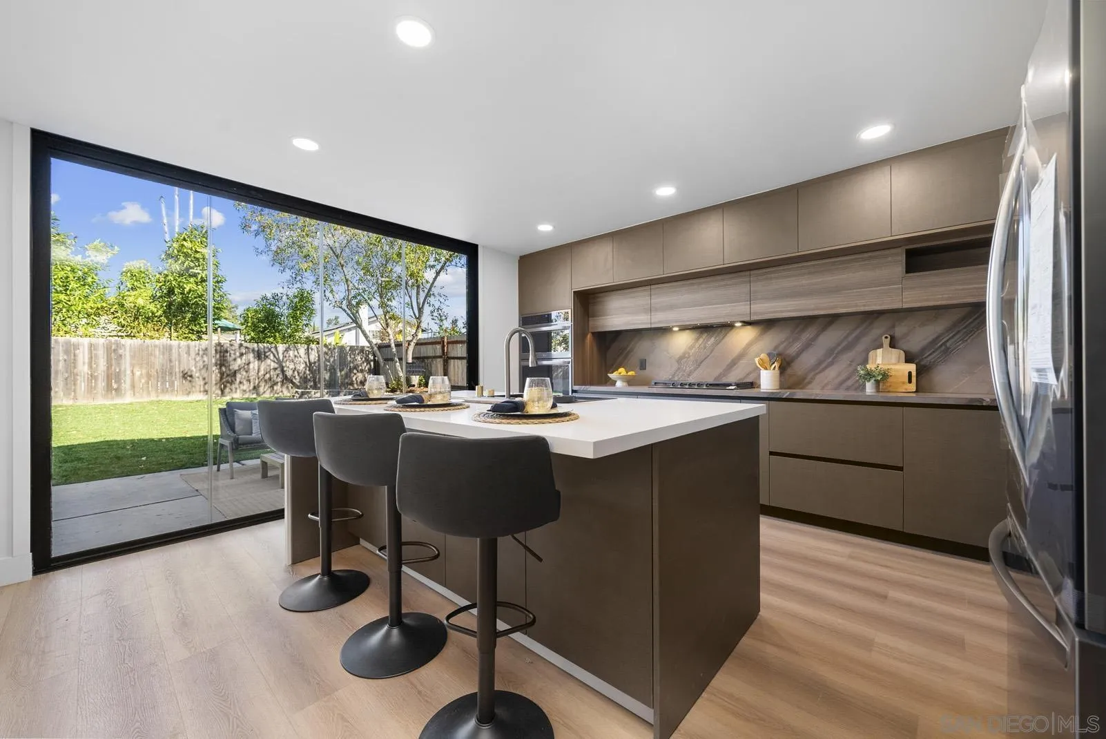 3523 Chauncey Road Oceanside, CA 92056 - Photo 14 of 34 a kitchen with a table chairs and microwave