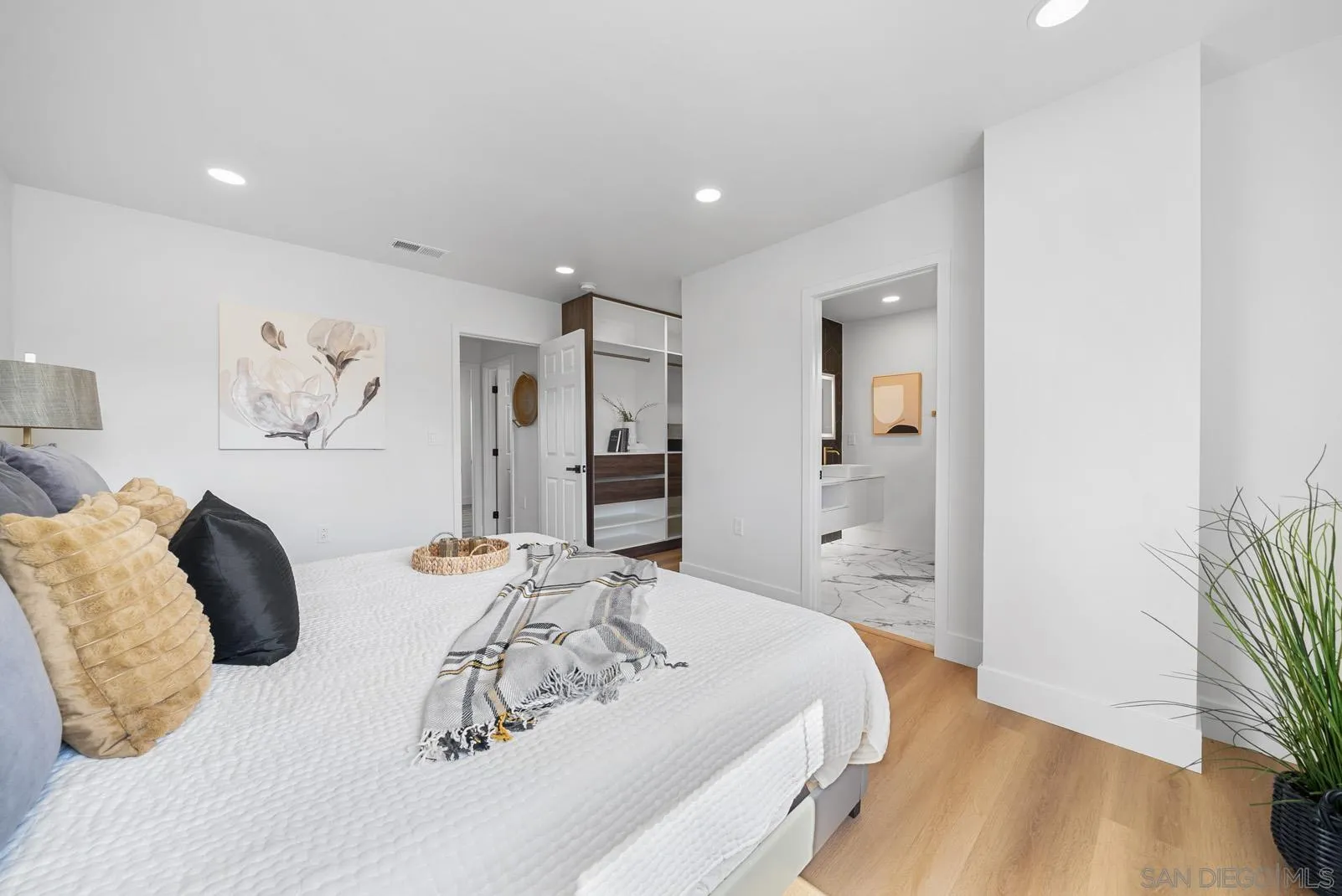 3523 Chauncey Road Oceanside, CA 92056 - Photo 21 of 34 a bedroom with a bed and a potted plant