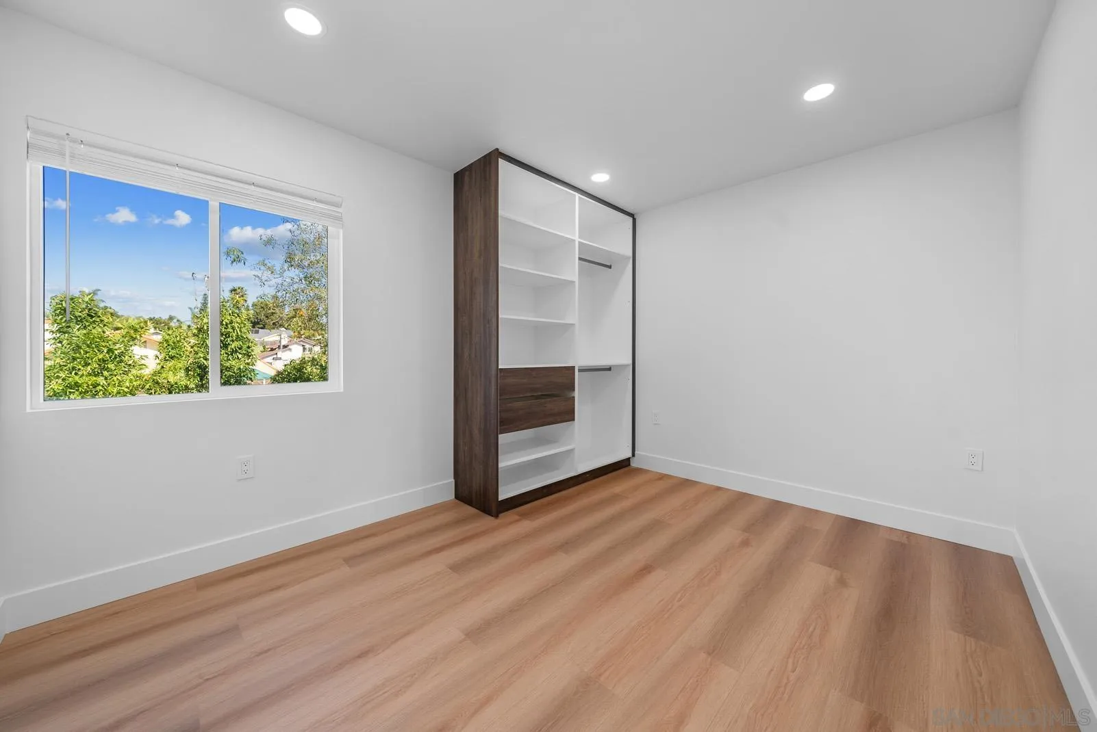 3523 Chauncey Road Oceanside, CA 92056 - Photo 24 of 34 wooden floor in an empty room with a window