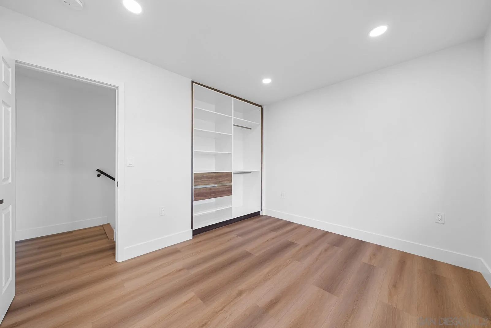 3523 Chauncey Road Oceanside, CA 92056 - Photo 26 of 34 a view of an empty room with wooden floor
