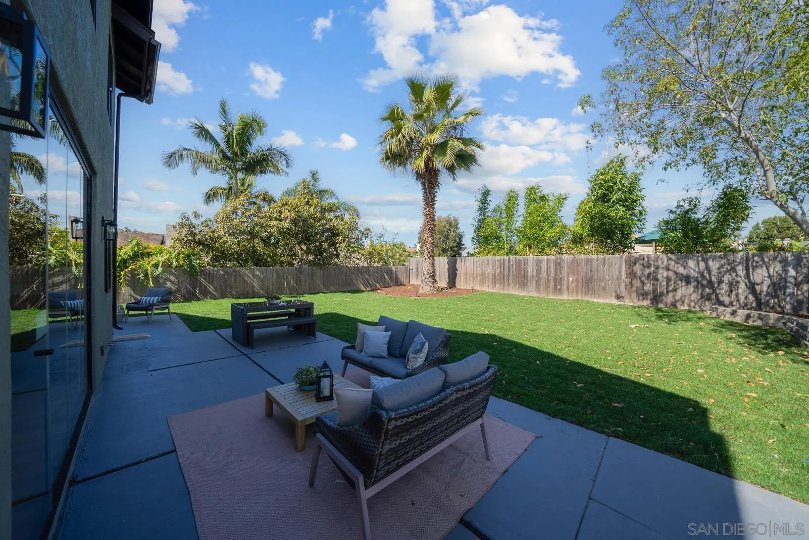 3523 Chauncey Road Oceanside, CA 92056 - Photo 28 of 34 a view of a backyard with couches plants and wooden fence