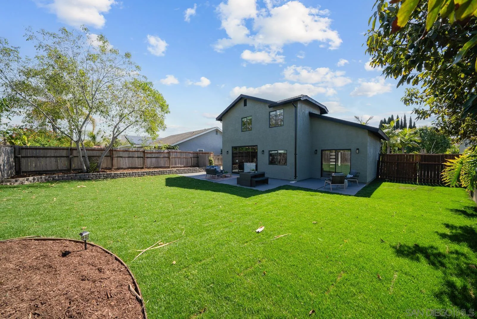 3523 Chauncey Road Oceanside, CA 92056 - Photo 30 of 34 a view of a house with a big yard potted plants and large tree