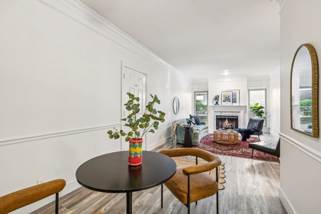 a living room with furniture fireplace and a potted plant