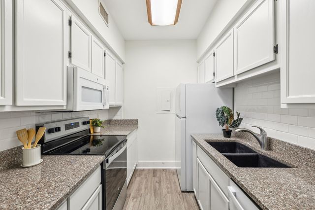 a kitchen that has a sink and a stove