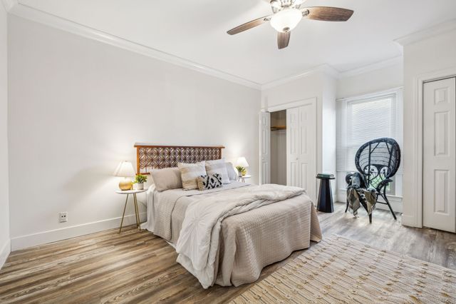 a bedroom with a bed and a chandelier