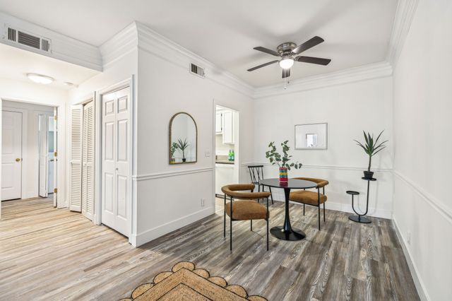 a workspace with wooden floor and furniture