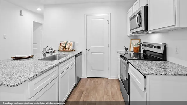 a kitchen with stainless steel appliances granite countertop a sink stove and cabinets
