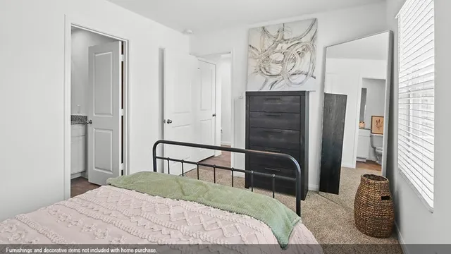 a bedroom with a bed table and a window