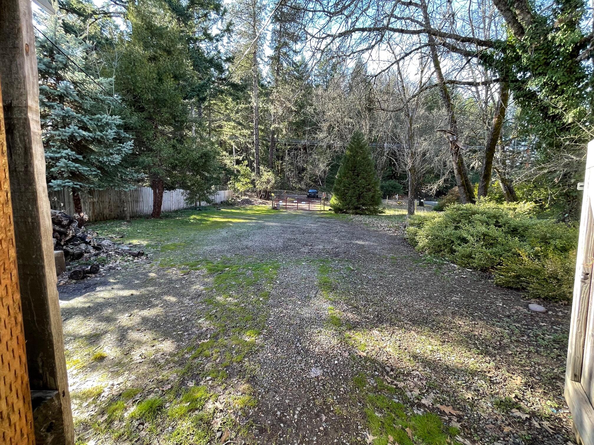 411 South Old Stage Road Cave Junction, OR 97523 - Photo 32 of 39 a view of a yard with plants and trees