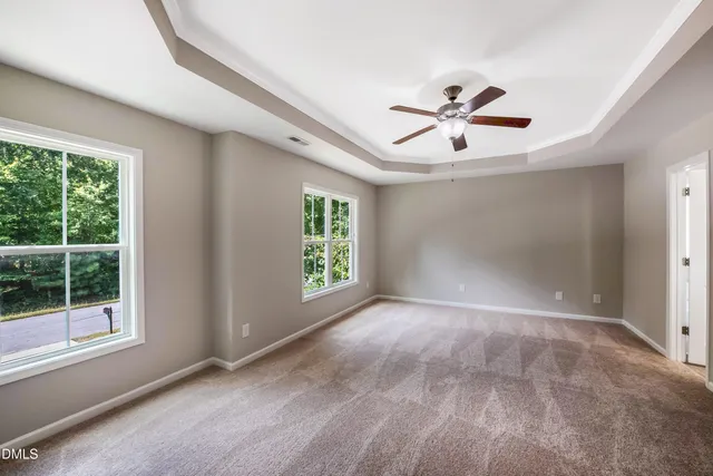 a view of a livingroom with a ceiling fan and window