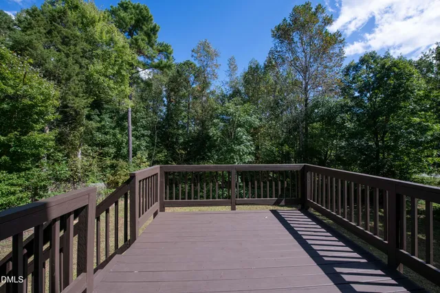 a view of balcony with deck and trees