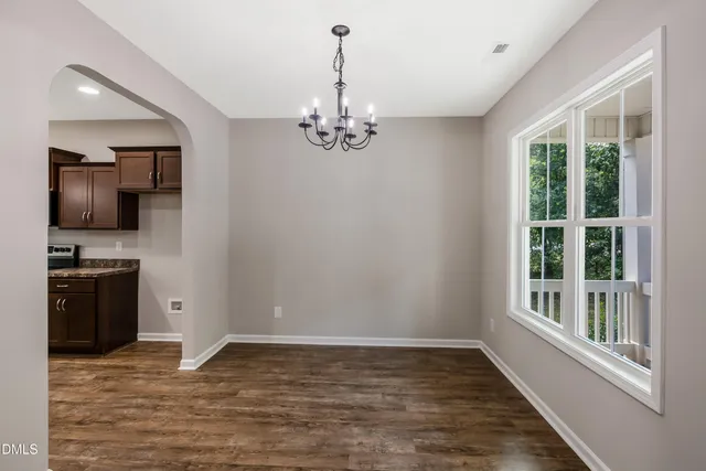 a view of a kitchen with granite countertop stainless steel appliances and wooden floor