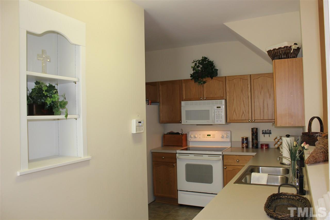2150 Metacomet Way Raleigh, NC 27604 - Photo 3 of 24 a kitchen with a stove a sink and a microwave