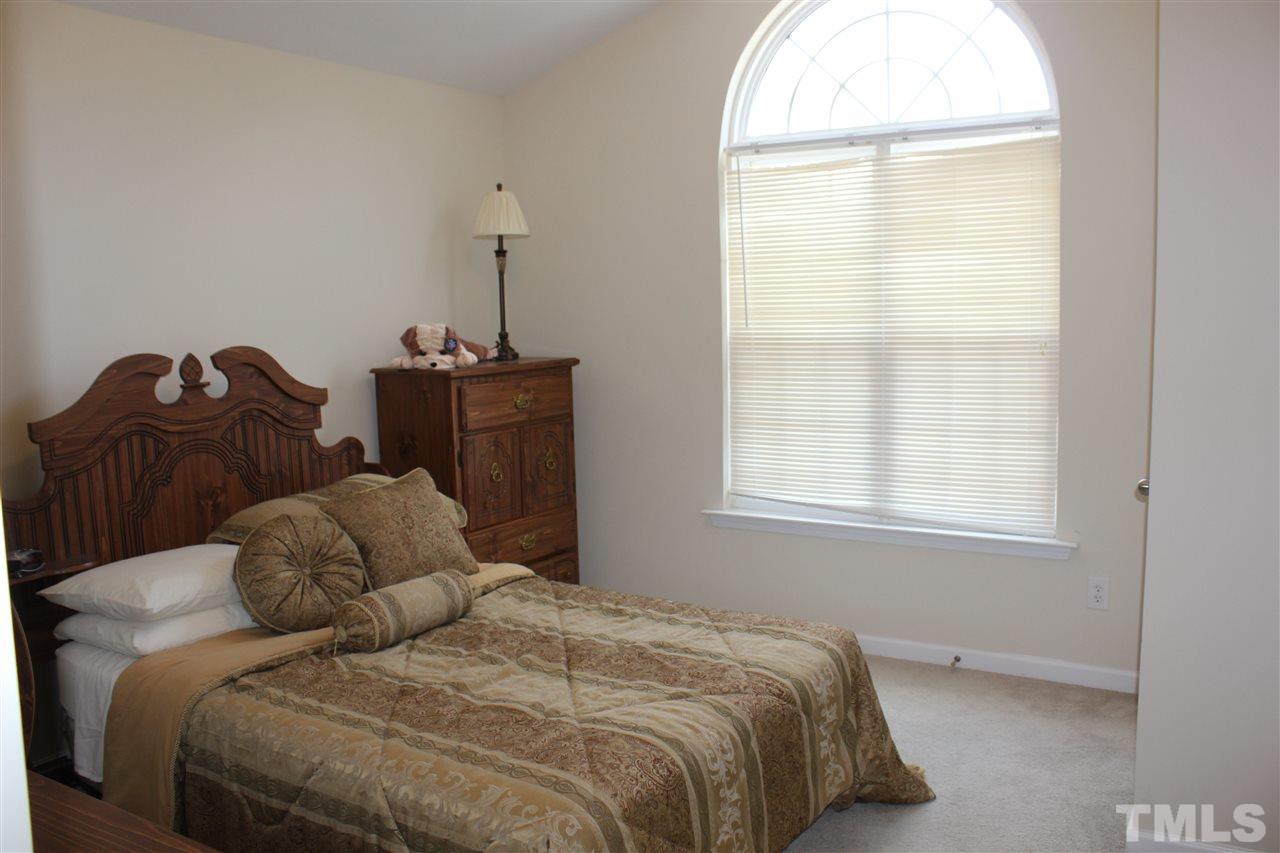 2150 Metacomet Way Raleigh, NC 27604 - Photo 8 of 24 a bedroom with a bed and a window