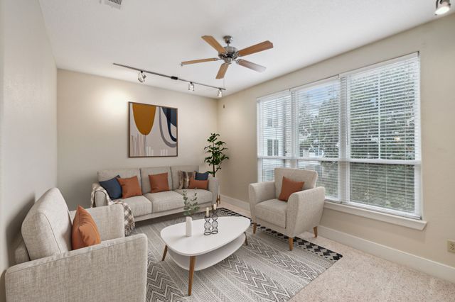 a living room with furniture and a large window