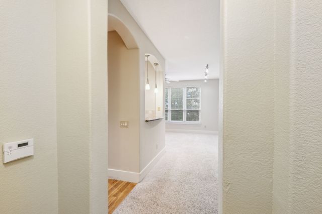 a view of a hallway with wooden shelves