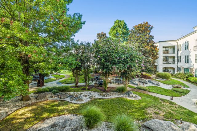 a view of backyard with a garden and outdoor seating