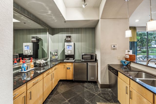 a kitchen with stainless steel appliances granite countertop a sink and cabinets