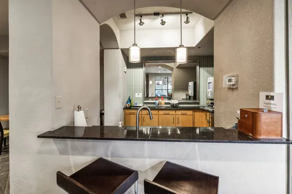 a kitchen with stainless steel appliances kitchen island granite countertop a stove and cabinets