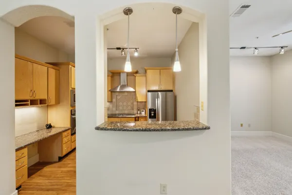 a view of kitchen with a sink and refrigerator