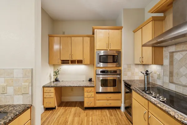 a kitchen with stainless steel appliances a stove sink and microwave