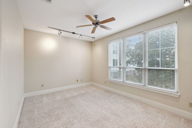 a view of a livingroom with a ceiling fan and window