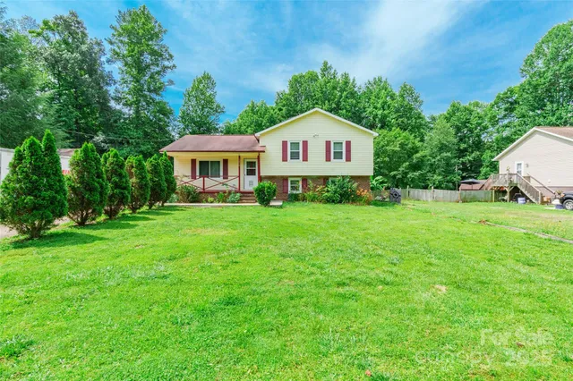 a view of a house with a yard and sitting area