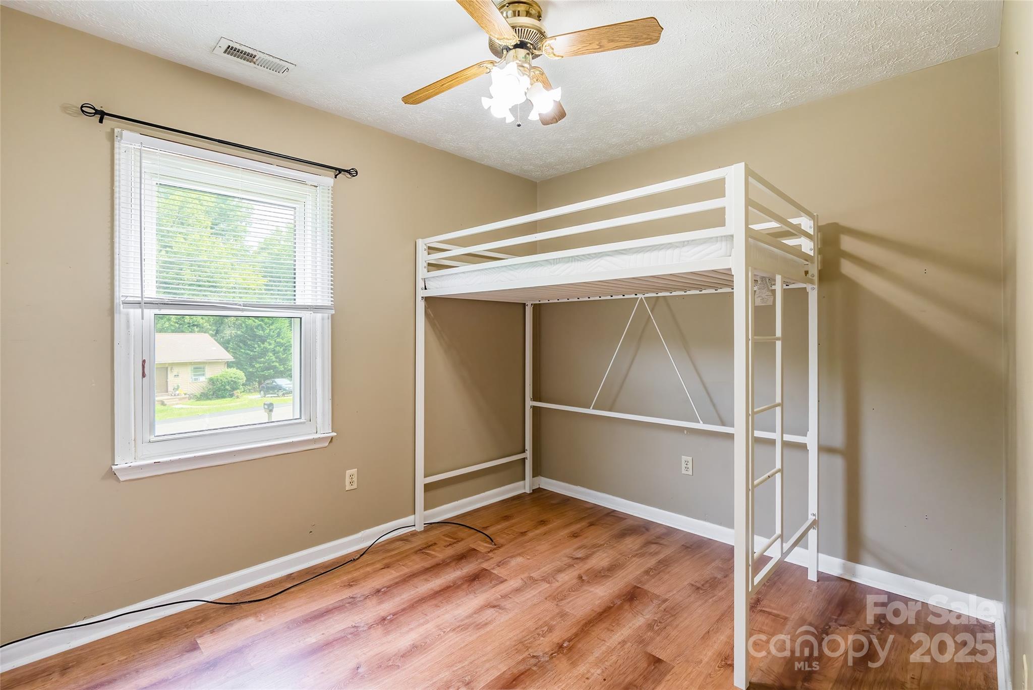 2675 Tablerock Road Lenoir, NC 28645 - Photo 14 of 31 a view of an empty room with a window and wooden floor